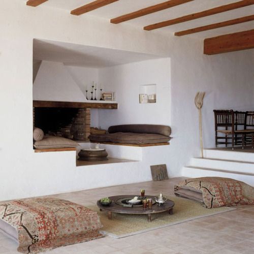 a welcoming fireplace nook with raised benches with cushions is amazing for staying there and relaxing
