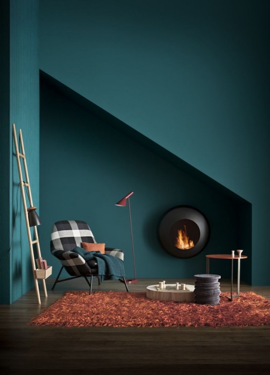 a stylish fireplace nook in the niche, with a round wall-mounted fireplace, a plaid chair with pillows, a couple of tables and a ladder