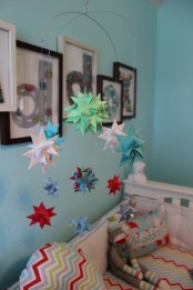 a bright nursery mobile with colorful 3D paper stars can be easily DIYed by you yourself and can make your kid’s room bolder