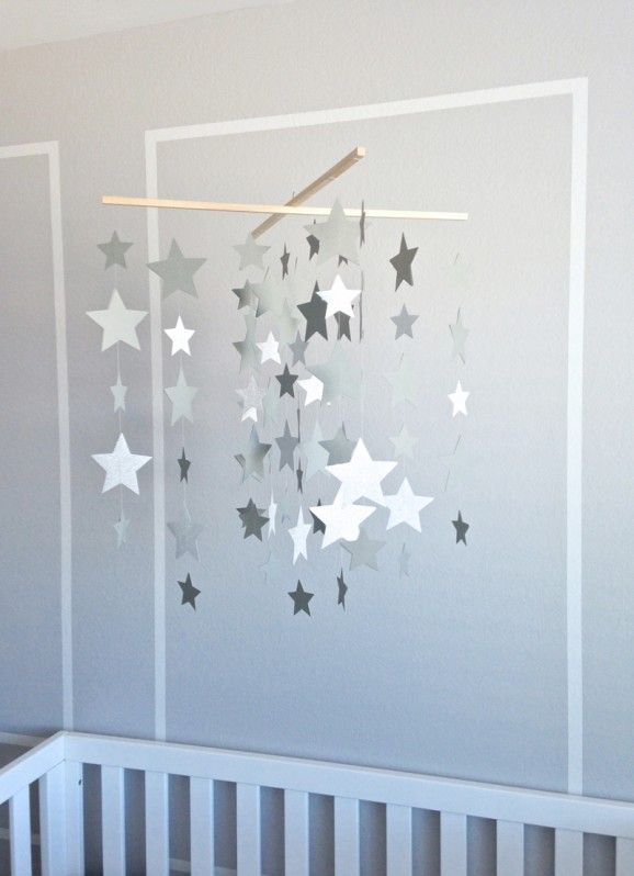 a pretty and timeless nursery mobile of grey and white cardboard stars hanging down is a cool idea for a modern neutral or Scandinavian space