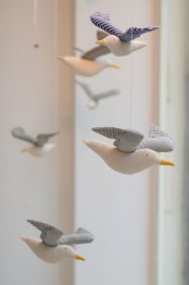 a cool nursery mobile with neutral fabric seagulls will be a great idea for a coastal or seaside space