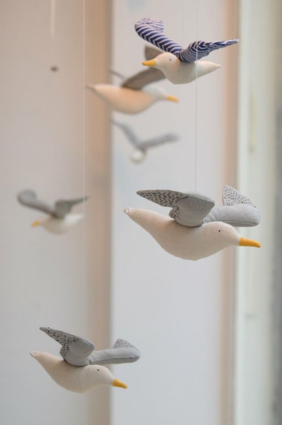 a cool nursery mobile with neutral fabric seagulls will be a great idea for a coastal or seaside space