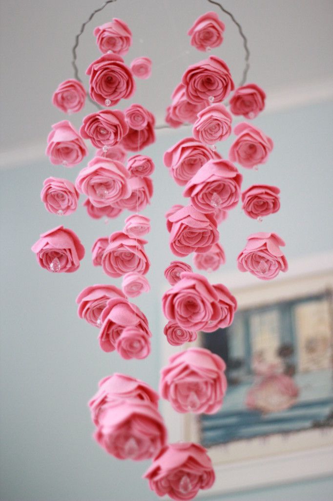 a gorgeous pink fabric rose mobile for a nursery, with beads and pearls is a beautiful solution for a flower infused space