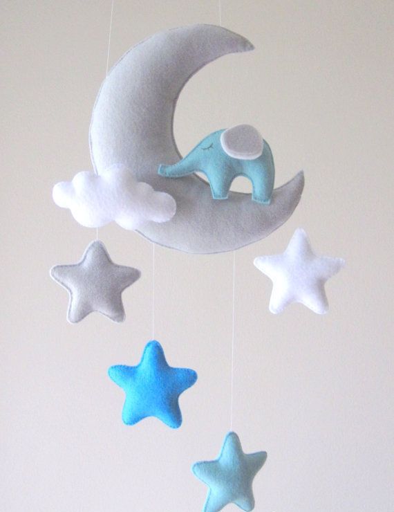 a dreamy nursery mobile with stars, clouds and a half moon is a cool and pretty idea for any nursery, it looks lovely and chic