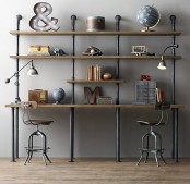 an industrial double working space with a single wood and metal shelving unit that includes desks, metal stools and pretty decor