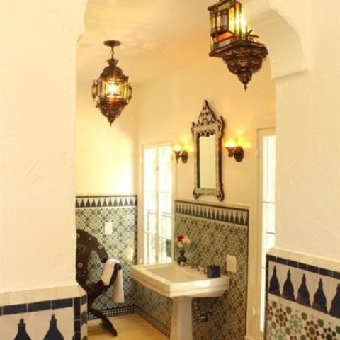 a neutral bathroom with mosaic tiles, Moroccan lanterns plus a catchy mirror in a wooden frame