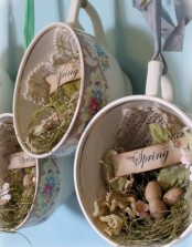 vintage teacups with moss, faux eggs, doilies, grass and dried blooms are beautiful vintage and rustic decorations