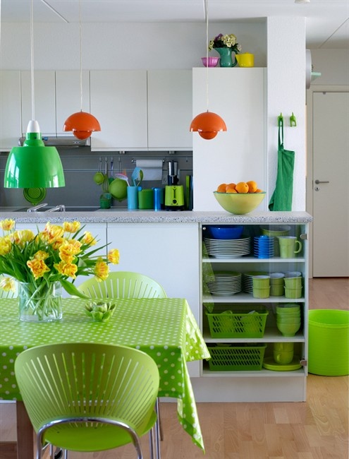 neon green linens, chairs, tableware and a green lamp refresh the kitchen and make it bright and fun