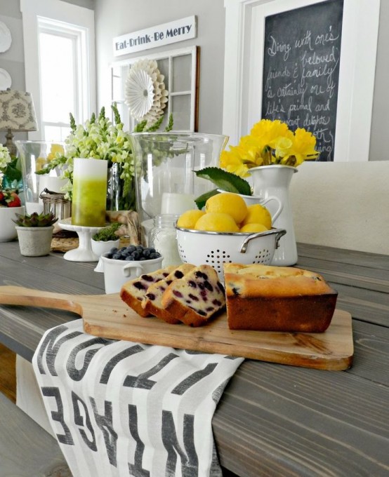 yellow blooms and lemons on the table make the tablescape look bright, fun and spring-infused