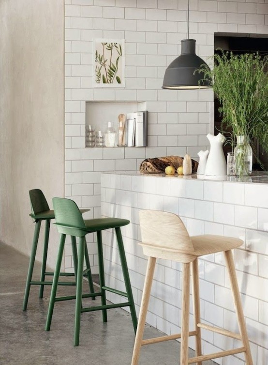 fresh greenery in a clear jar and green chairs will make the kitchen feel more outdoor-like