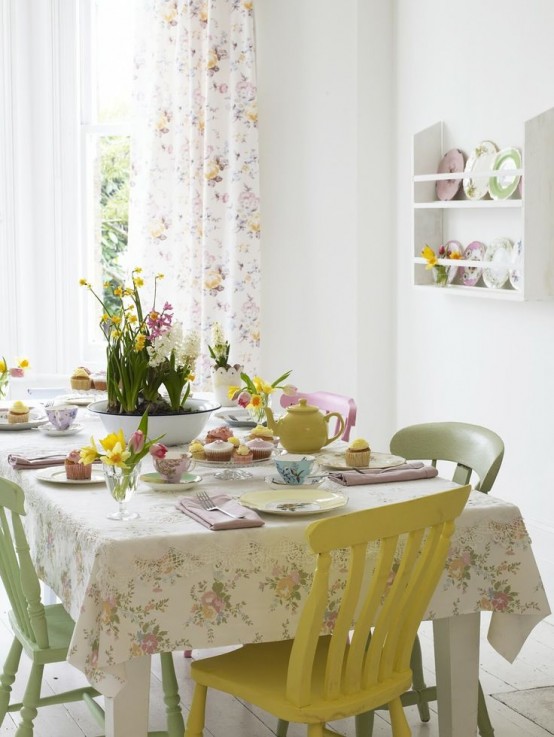 floral linens, pastel chairs, pastel tableware and plates make the dining space look more spring-like