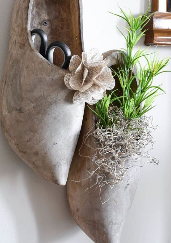 traditional Dutch wooden shoes with greenery in them hanging on the wall are a creative and cool spring decor idea