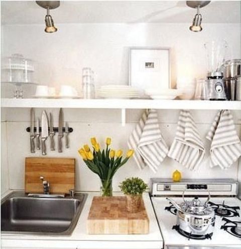 yellow tulips, fresh greenery in a pot make the kitchen fresher, brighter and more spring-like