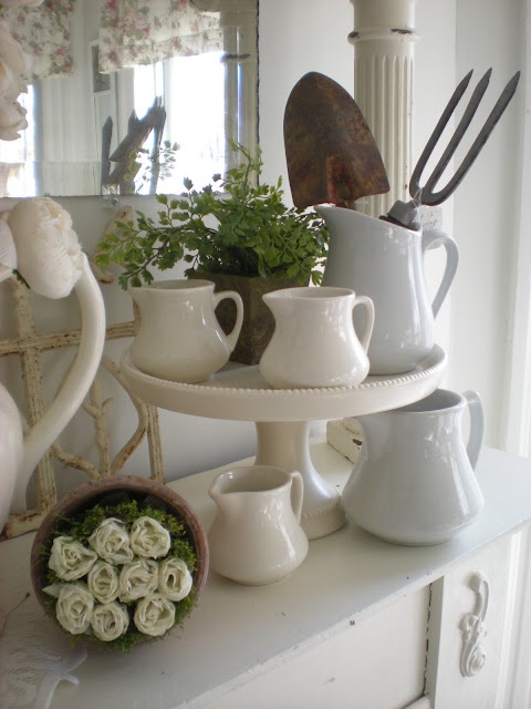 rustic and vintage spring mantel styling with fake white roses, moss and garden tools