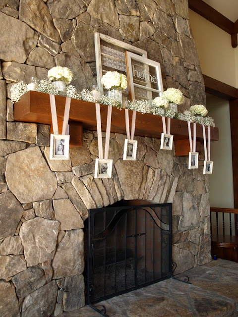 baby's breath, hydrangea arrangements in glasses and hanging photos of the whole family