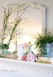 fake blooms and blooming branches, potted greenery and a bunny figurine