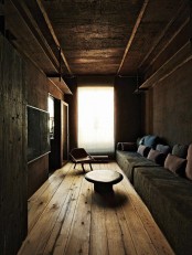 add wabi-sabi aesthetics to your space with stone walls, rough wooden touches and a metal ceiling