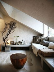 a minimalist meets wabi-sabi living room with rough stone walls and a wooden bench, faux fur and pillows