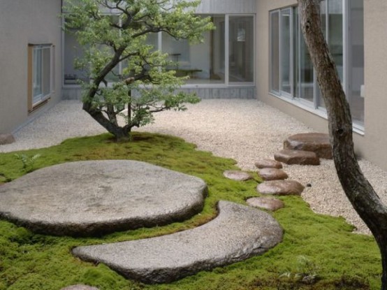 a fantastic Japanese inspired garden with pebbles, large flat rocks, moss and a couple of trees is very calming and soothing
