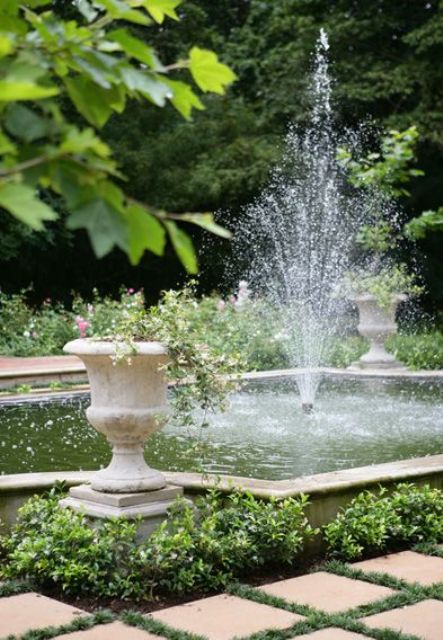 a fun and refreshing fountain right in the middle of a decorative pond is a fun and cool idea for pets and kids