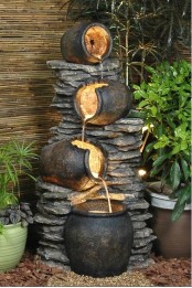 a cool and unusual fountain of stone and vessels that look like planters is a lovely idea for a fairy-tale styled garden