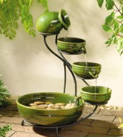 a green porcelain mini fountain of a vase and several matching bowls of different sizes is a lovely idea for a small garden