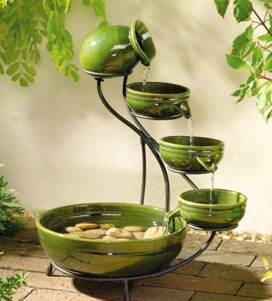 a green porcelain mini fountain of a vase and several matching bowls of different sizes is a lovely idea for a small garden a green porcelain mini fountain of a vase and several matching bowls of different sizes is a lovely idea for a small garden