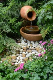 a small and delicate fountain of a porcelain vase and bowls is a lovely idea for a small garden – you get a fountain that doesn’t take much space