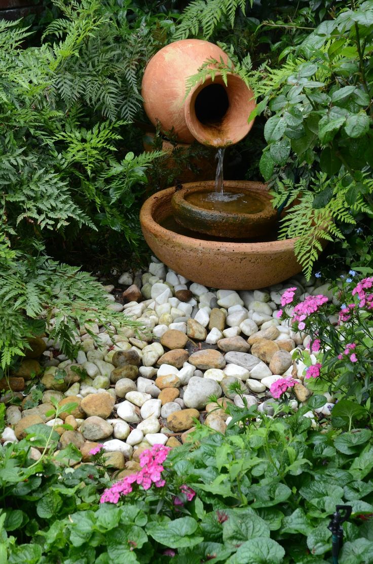 a small and delicate fountain of a porcelain vase and bowls is a lovely idea for a small garden   you get a fountain that doesn't take much space