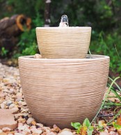 a neutral stone bowl fountain is a lovely idea for a zen or Asian garden, it will accent your minimalist garden, too