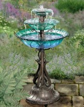 a refined mini tiered fountain with a metal leg and blue and green tiers of glass is a creative idea if you don’t have much space for a fountain