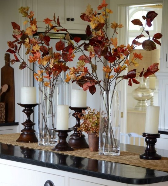 clear vases with dark fall leaves and candles in refined wooden candle holders are chic and stylish for a rustic tablescape