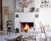 Living Room With A Fireplace Surrounded Painted Fieldstone