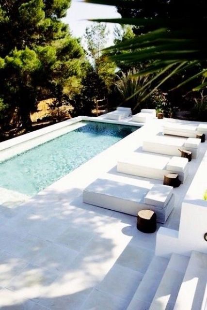 long plunge outdoor pool with a white deck