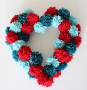 a colorful pompom heart-shaped wreath is a nice decoration for Valentine’s Day or just for romantic decor