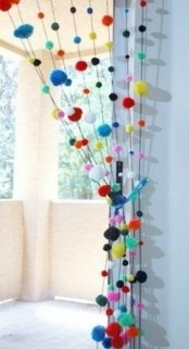 colorful pompom curtains to divide the balcony from the rest of the interior – it’s an easy way to do that and you can DIY that