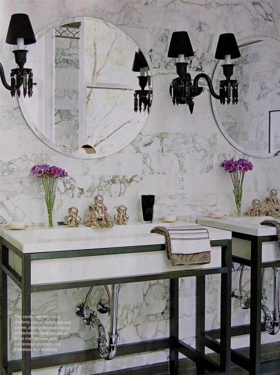 a luxurious white marble bathroom with sinks on stands, elegant black lamps and round mirrors