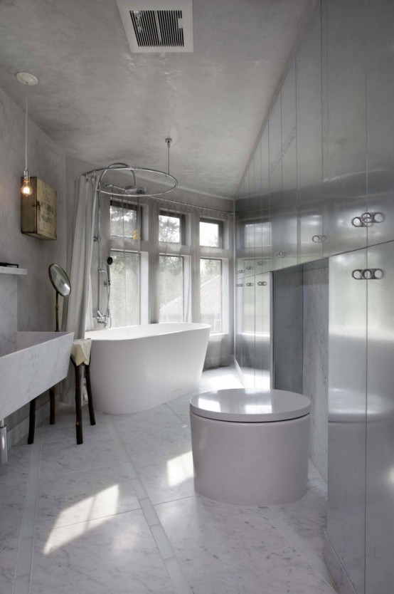 an unusual white marble bathroom done with metal panels, an oval tub and a sculptural sink of marble