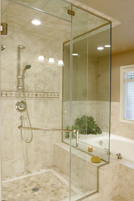 a neutral and warm-colored bathroom with marble tiles on the floor, walls and tub plus elegant hardware