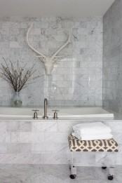 a white marble bathroom done with tiles – an amazing idea to use if you arne’t ready to splurge on real marble