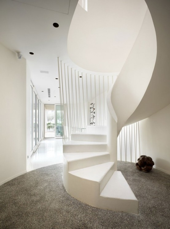 Luxurious White Apartment With Sculptural Wood And Stone Objects