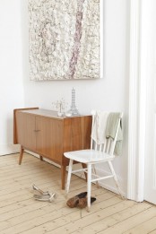 a light-stained mid-century modern cabinet on tall legs is a cool idea for a modern space – a living room, an entryway, a bedroom