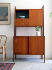 a large rich-stained mid-century modern cabinet with two parts and tall legs will save a lot of space letting you store a lot of things at the same time