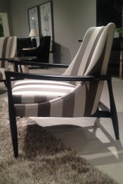 a stylish striped chair with a black frame is a cool idea for a modern or vintage space, it catches an eye