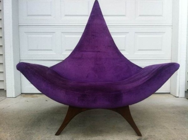 a bold and catchy purple mid century modern chair with a pointed back and tall legs, with armrests is a stylish idea for adding color and a sharp touch with its design