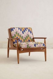 a mid-century modern to boho chair with a stained frame, armrests and legs and bright geo printed upholstery