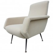 a white mid-century modern chair with sculptural armrests and tall metal legs is a cool and chic idea for a mid-century modern space