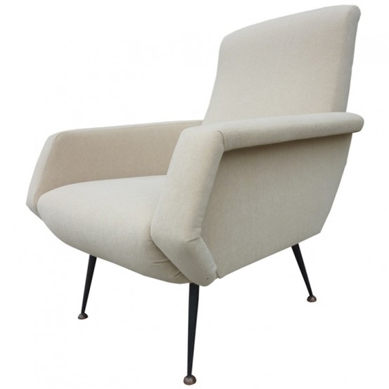 a white mid-century modern chair with sculptural armrests and tall metal legs is a cool and chic idea for a mid-century modern space