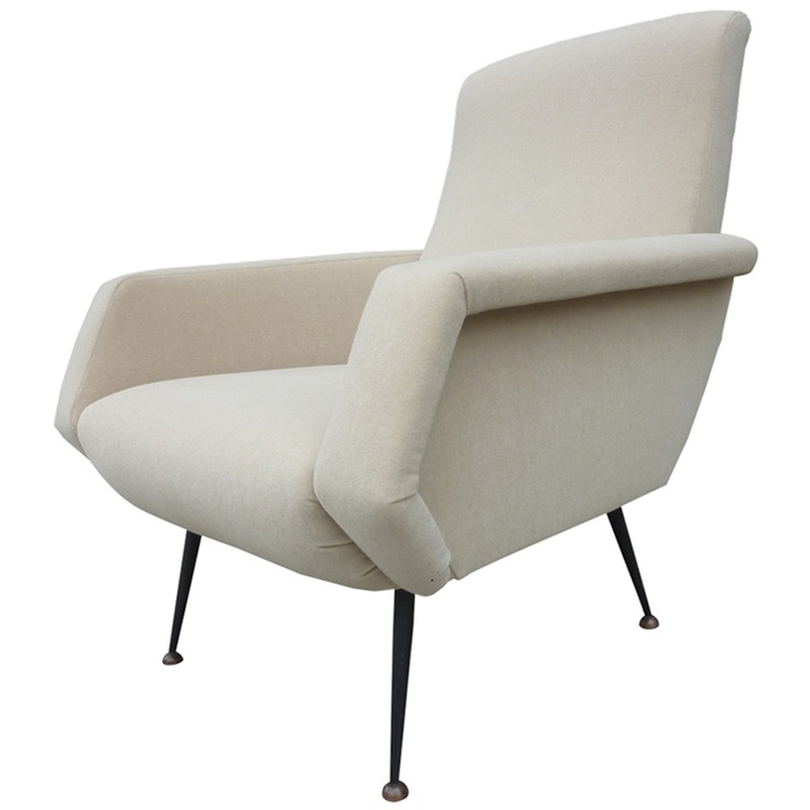 a white mid century modern chair with sculptural armrests and tall metal legs is a cool and chic idea for a mid century modern space