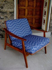 a bold mid-century modern chair with a rich-stained frame and legs plus bright printed upholstery will make a statement with its color and print